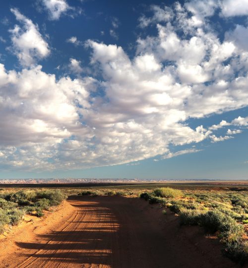 clouds-desert-dirt-road-150958